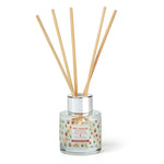 Reed diffuser with wooden sticks in a glass container on a white background