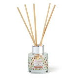 Reed diffuser with wooden sticks in a glass container on a white background
