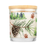 Candle with a wooden lid featuring pine branches, pinecones, and paw prints on a white background.
