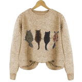 Beige sweater with cat illustrations on a hanger against a white background