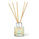 Reed diffuser with wooden sticks in a glass container on a white background