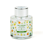 Clear glass diffuser bottle with a colorful label on a white background