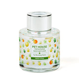 Clear glass diffuser bottle with a colorful label on a white background