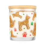 Candle with gingerbread dog pattern on a white background