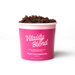 Pink container of 'Vitality Blend' whole food supplement for dogs on a white background