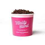 Pink container of 'Vitality Blend' whole food supplement for dogs on a white background
