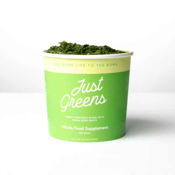 Green container of 'Just Greens' whole food supplement for dogs on a white background