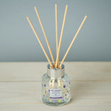 Diffuser with wooden sticks on a gray background