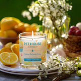 Pet House Candle labeled 'Lemon Cupcake' on a table with lemons and flowers