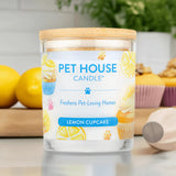 Pet House Candle labeled 'Lemon Cupcake' on a kitchen counter with lemons and baking items.