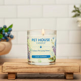 Pet House Candle in Lilac Garden scent on a wooden stand with a white tiled wall background