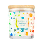 Candle with colorful paw prints and text on a white background