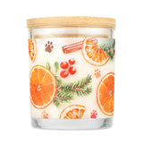 Candle with a decorative label featuring oranges, cinnamon sticks, and berries on a white background