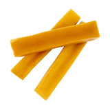 Three yellow dog treats on a white background