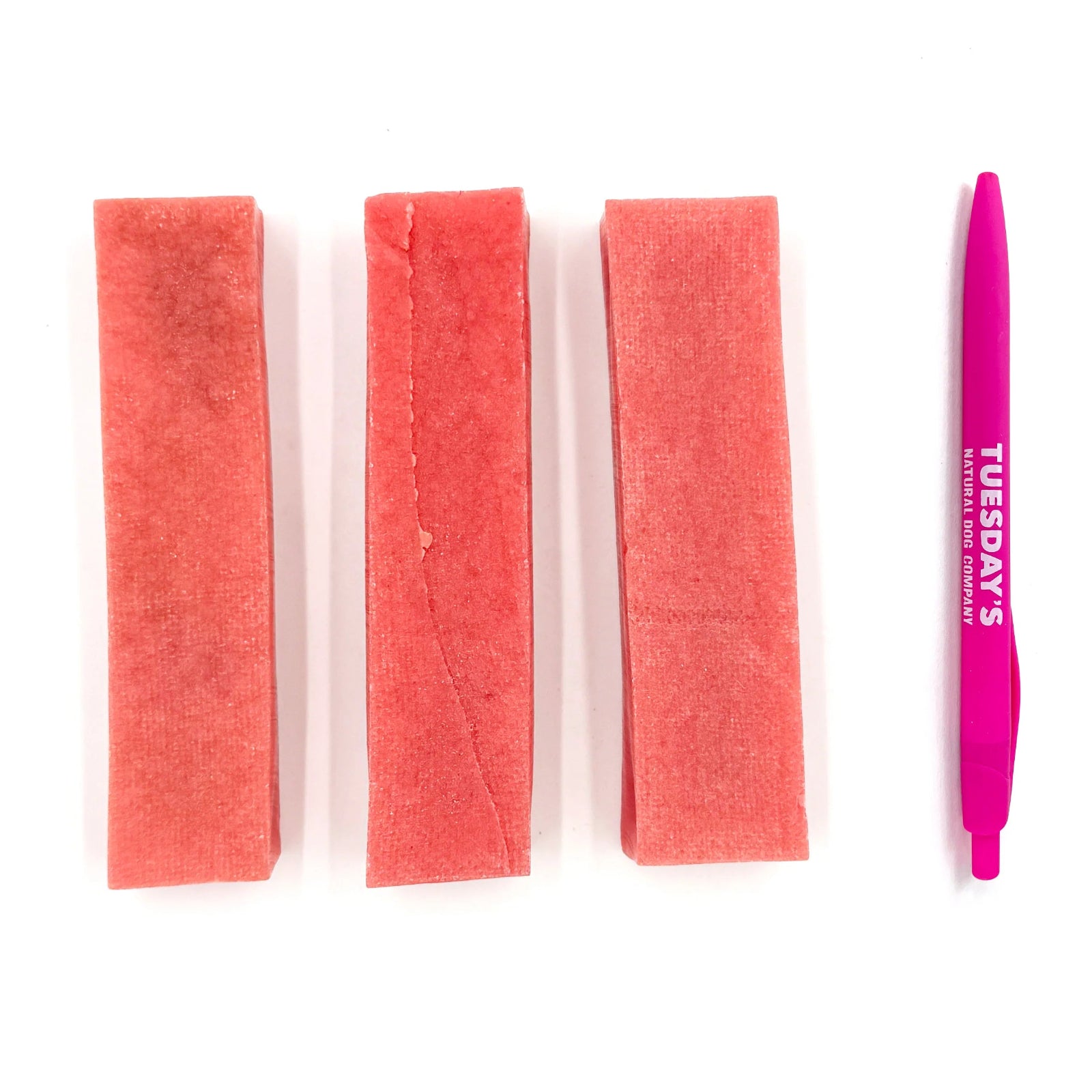 Three strips of pink scrubber pads and a pink tool with 'Tuesday's' branding on a white background