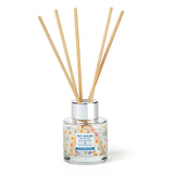 Reed diffuser with wooden sticks in a glass container on a white background