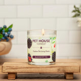 Pet House Candle on a wooden stand with a white tiled wall and decorative elements in the background