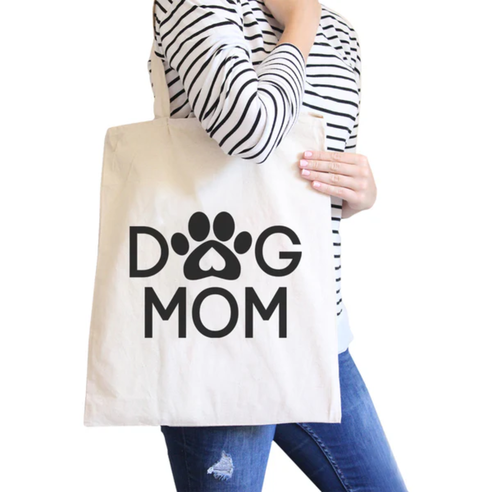 Person holding a tote bag with 'Dog Mom' text and paw print design.