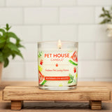 Pet House Candle on a wooden stand with plants and flowers in the background