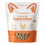 A stand-up pouch of Small Batch Cat Freeze Dried Meal Bites, Farm Fresh Chicken Recipe. The packaging is white and orange with a clear window showing the freeze-dried kibble inside.