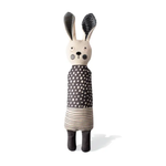 Toy rabbit with a polka dot dress on a white background