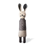 Toy rabbit with a polka dot dress on a white background