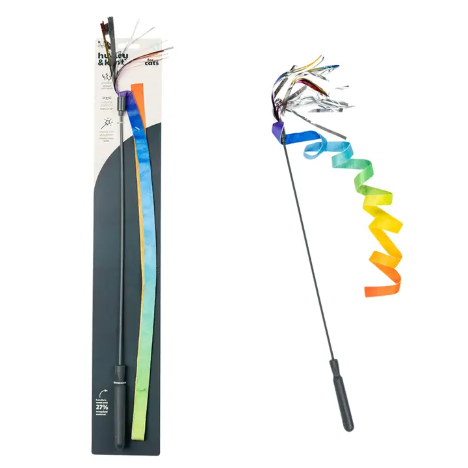 A long black wand-style toy with a spiral rainbow ribbon attached, shown both in its retail packaging on the left and unpackaged on the right against a white background.