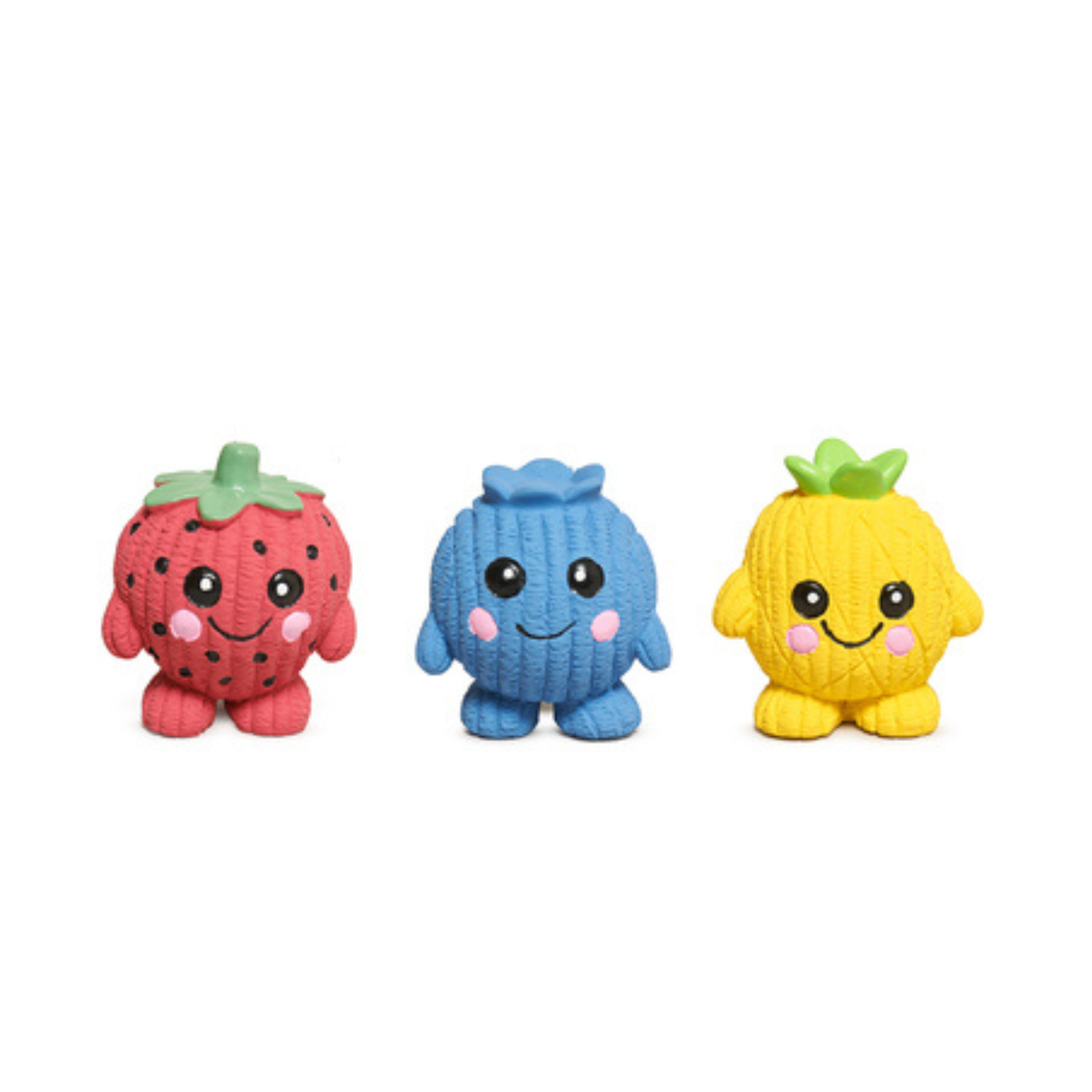Three small knitted plush toy characters on a plain white background: a strawberry in red with green leaves, a blue round character, and a yellow pineapple with green leaves.