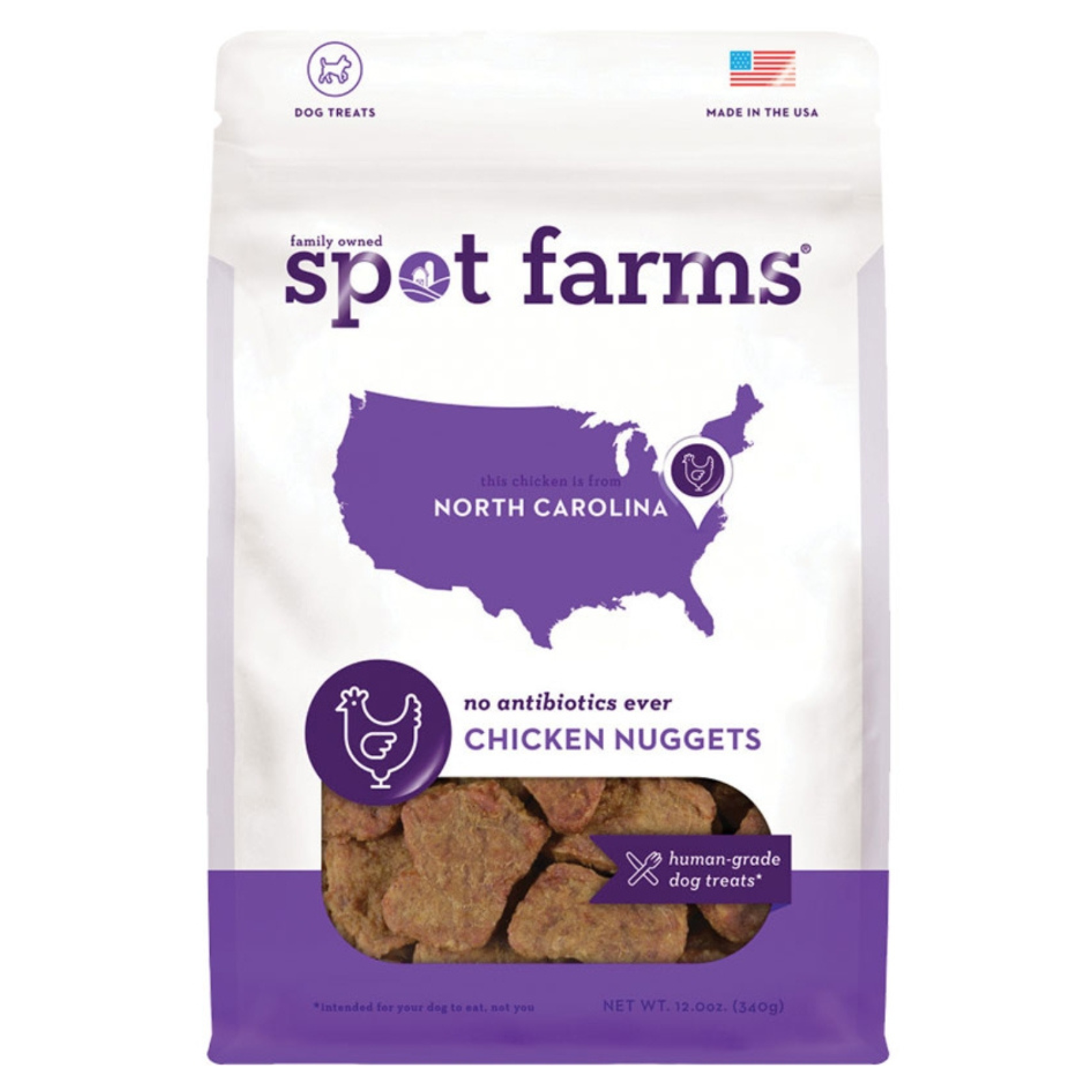 A 12 oz bag of Spot Farms Organic North Carolina Chicken Nuggets dog treats. The white and purple bag features a map of North Carolina, a chicken icon, and a clear window showing the brown kibble inside.