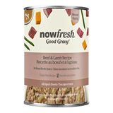 A can of Now Fresh Good Gravy Beef & Lamb Recipe dog food on a plain white background. The can features a cream-colored label with illustrations of beef, lamb, green beans, and carrots, a dusty pink band with the product name in English and French, and a clear bottom window showing the wet food inside.