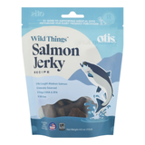 A package of Otis Wild Things Salmon Jerky Recipe dog treats, featuring a light blue and white bag with an illustration of a salmon jumping, on a white background.