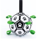 A dog toy shaped like a soccer ball with black and white panels, paw print patterns, and bright green hanging loops, shown against a plain white background.
