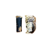 Two small natural shell or bone-like pieces shown upright on a plain white background, one dark blue-black with tan areas and the other beige with dark marbling.