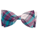 A pre-tied bow tie featuring a multicolor plaid pattern with teal, magenta, purple, and white stripes, displayed on a clean white background.