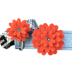 A light blue denim-style pet collar with two large orange felt flower embellishments on the front, each with a small clear rhinestone center, shown on a white background.
