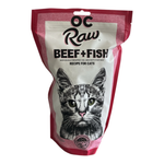 A bag of OC Raw Beef + Fish recipe for cats, featuring a white and pink package with a detailed black and white cat illustration on the front.