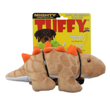 A Tuffy brand plush dinosaur dog toy in tan with orange spikes and a black harness, shown in front of its yellow retail packaging card.