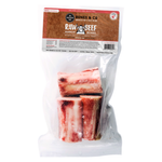 Raw beef marrow bones for pets in a clear plastic bag with a brown and white header label. The bones are visible through the transparent packaging, showing pinkish-red marrow and off-white bone sections.