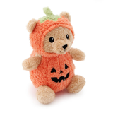 A plush teddy bear wearing a fuzzy orange pumpkin costume with a green stem and embroidered black jack-o'-lantern face, photographed on a clean white background.