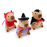 Three small plush capybara toys dressed in Halloween costumes, including a red devil outfit, a purple witch outfit with a black hat, and a black vampire outfit with a red bow tie, set against a plain white background.