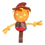 A plush scarecrow dog toy with an orange pumpkin head, brown hat, yellow braided straw arms, and a red plaid shirt, shown on a plain white background.