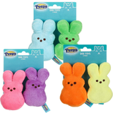 Four packages of Peeps plush dog toys on a white background, each containing two marshmallow-shaped bunny toys in different colors: light blue, green, pink, purple, orange, and yellow.