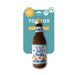 A plush dog toy shaped like a beer bottle, hanging from its teal retail card packaging. The toy is brown with a floral label that reads 'Let's Fiesta' and a gold-colored top cap.