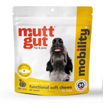 A package of mutt gut Mobility dog joint support soft chews, pumpkin flavored, in a white and yellow resealable stand-up pouch with a photo of a black and white dog on the front.