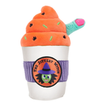 A plush toy shaped like a Halloween-themed drink cup, with orange whipped-cream swirl, green and black sprinkles, a purple ribbed band, and a circular 'The Jittery Witch' logo patch. A small teal handle with a pink tip extends from the side.