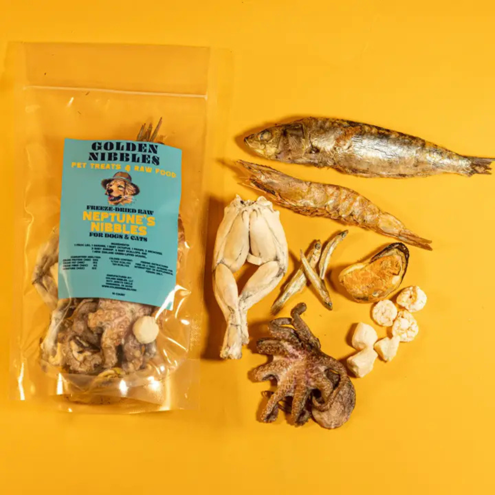 A clear stand-up pouch of GoldenNibbles pet nibbles treats with a blue label, arranged on a bright yellow background alongside whole dried fish, shrimp, mussels, scallops, frog legs, and octopus. The packaging text reads 'GoldenNibbles and 'Neptune's Nibbles.'