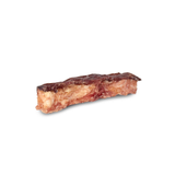 A single slice of cured meat, likely a salami or pepperoni slice, showing a dark reddish-brown rind and a pale pinkish-red interior, isolated on a white background.