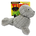A gray plush dog chew toy shaped like a seal or puppy, shown in front of its yellow retail packaging card. The packaging features the brand name 'TINY' and text including 'Mighty Construction' and 'Soft, Yet Mighty Strong!'.