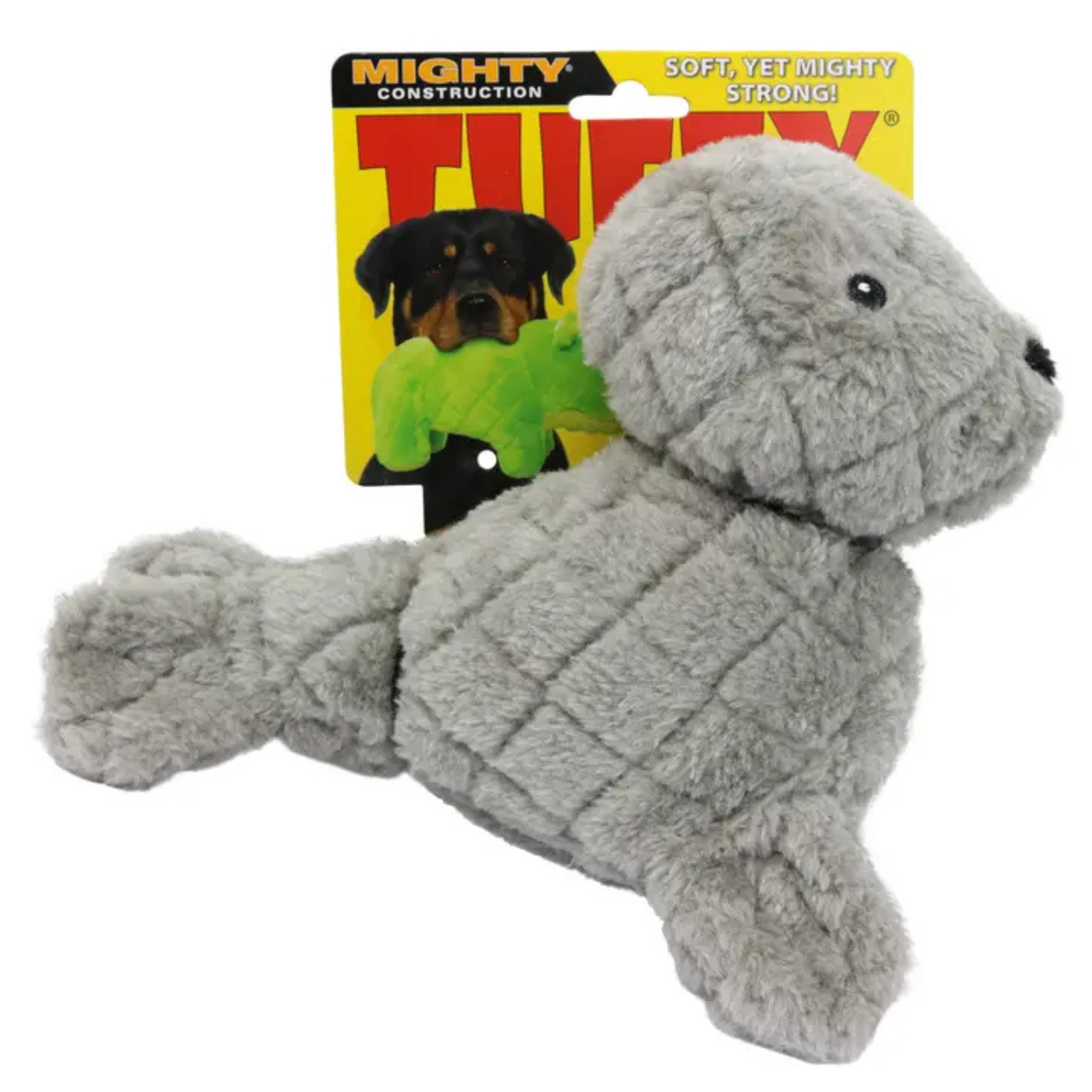 A gray plush dog chew toy shaped like a seal or puppy, shown in front of its yellow retail packaging card. The packaging features the brand name 'TINY' and text including 'Mighty Construction' and 'Soft, Yet Mighty Strong!'.