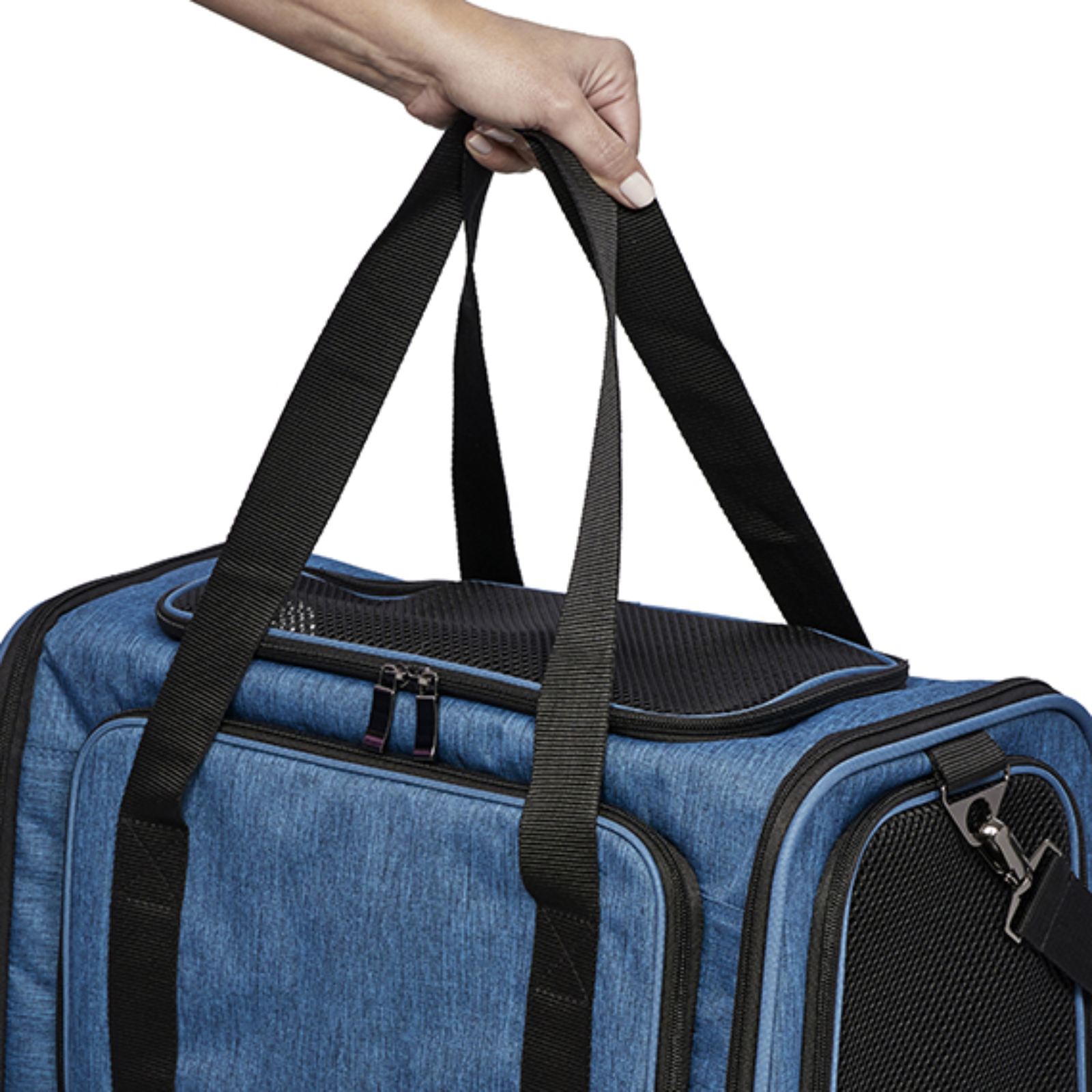 A blue pet carrier duffel bag with black handles and black mesh ventilation panels, shown with a person's hand holding the top handle against a white background.